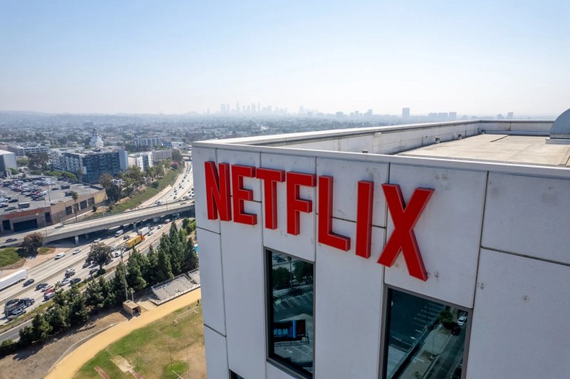 Netflix tops estimates but shares fall over Warner bid