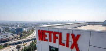 Netflix tops estimates but shares fall over Warner bid